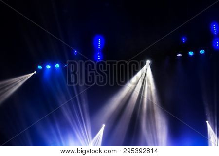 Stage Lights. Several Projectors In The Dark. Multi-colored Light Beams From The Stage Spotlights On