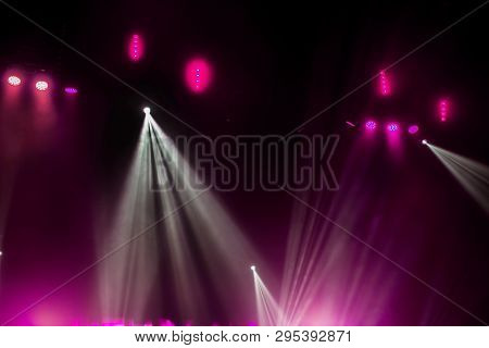 Stage Lights. Several Projectors In The Dark. Multi-colored Light Beams From The Stage Spotlights On