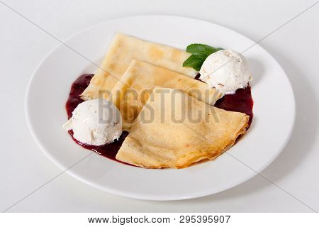 Crepes Suzette: French Thin Pancake With Orange Sauce And Ice Cream