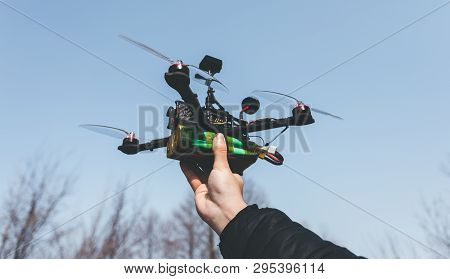 Pilot Racing Drone Holds In His Hand Fpv Copter Before Launching It. A Small High-speed Aircraft Wit