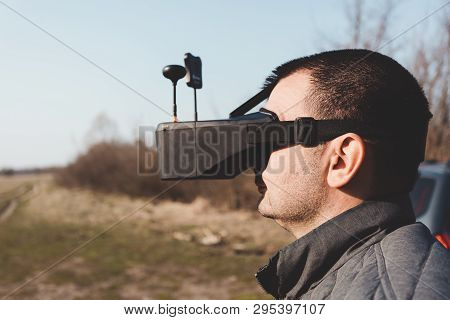 Fpv Drone Pilot In A Virtual Reality Helmet With A Remote Control From A Copter Flies In Aircraft Ou