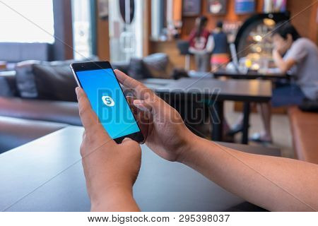 Chiang Mai, Thailand - Mar 18,2018: Man Holding Huawei With Skype Apps. Skype Is Part Of Microsoft, 
