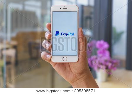 Chiang Mai, Thailand - Mar 02,2018: Man Holding Apple Iphone 6s Rose Gold With Paypal Apps On Screen