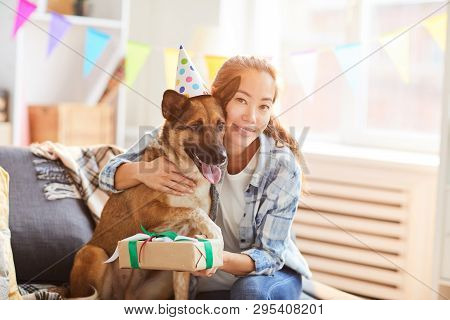 Portrait Of Asian Woman Hugging Gog While Celebrating Birthday, Copy Space