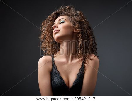 Portrait Of A Beautiful Female Fashion Model With Curly Hair
