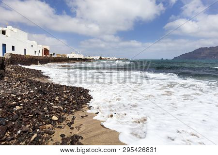 Stones And White Houses At The Coast Of Caleta De Sebo On The Island La Graciosa Of Lanzarote