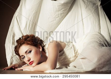 Vintage Portrait Of A Glamourous Queen Like Girl In Bedroom. Retro Style. Daylight. Studio Shot