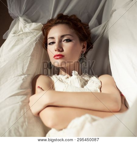 Vintage Portrait Of A Beautiful Queen Like Girl In Bedroom. Retro Style. Daylight. Studio Shot