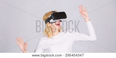 Woman Wearing Virtual Reality Goggles. Amazed Young Woman Touching The Air During The Vr Experience.