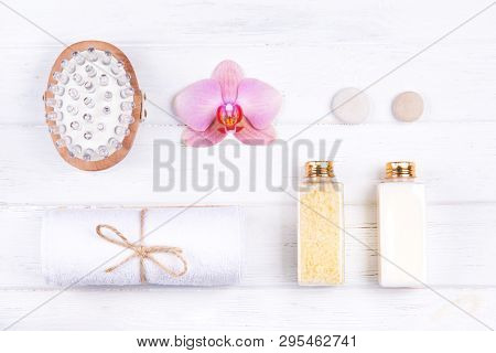 Top View Of Different Spa, Beauty And Wellness Products: Cream, Sea Salt, Towels, Massage Brush And 
