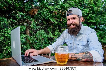 Finally Friday. Hipster Relax Sit Terrace Outdoors With Beer. Bearded Hipster Freelancer Enjoy End O