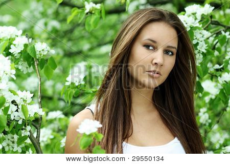ภาพของสาวสวยหอมดอกไม้สีขาวในสวน