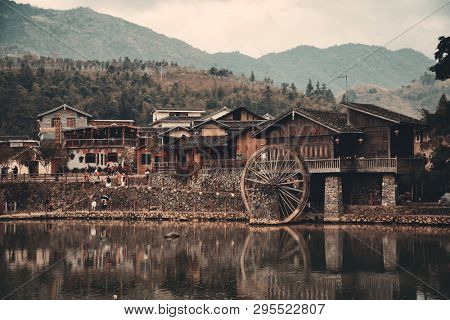 FUJIAN, CHINA â MARCH 2, 2018: Yunshuiyao old town by the river with watermill in Fujian, China.