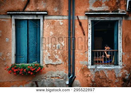 VENICE - MAY 27: A man working on laptop on May 27, 2016 in Venice, Italy. With nearly 2 thousand years of history, the city is one of the top attractions in Italy.