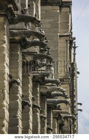 Exhaulted Horizontal View Of Interior Of Notre Dame Of Paris, France In Golden Lights On Ancient Sto