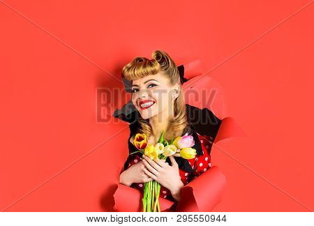 Smiling Retro Woman Looking Through Hole In Paper. Pin Up Woman With Tulips Looking Through Paper. P