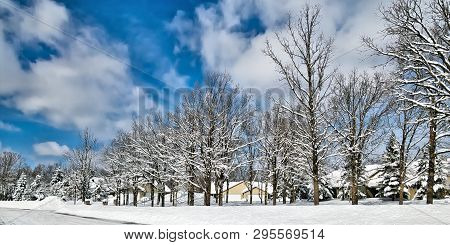 Snow Piles In Front Of Houses In Minnesota Residential Community After Winter Storms With Snow Cover
