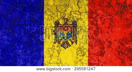 National Flag Of Moldavia On The Background Of The Old Wall Covered With Peeling Paint. Concept Of C