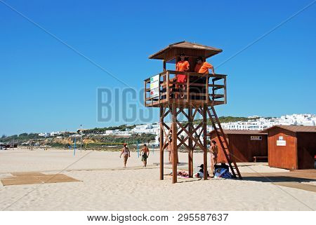 Conil De La Frontera, Spain - September 14, 2008 - Lifeguards On A Wooden Tower On The Beach With To