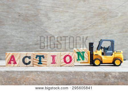 Toy Forklift Hold Letter Block N To Complete Word Action On Wood Background