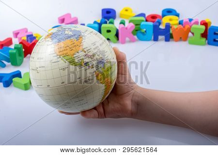 Little Model Gobe In Hand With Colorful Letters Behind