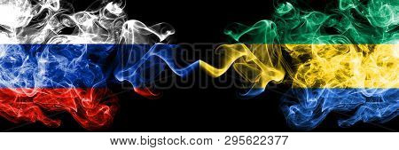Russian Vs Gabon, Gabonese Smoke Flags Placed Side By Side. Thick Colored Silky Smoke Flags Of Russi