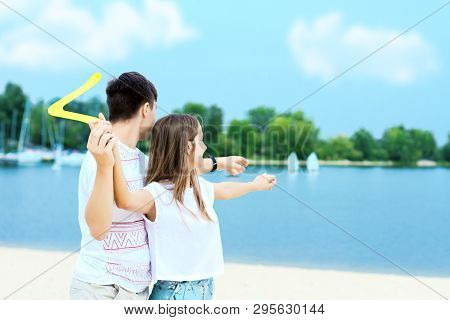 Young Smiling Woman In Light Clothes Is Holding White Racket And Ball In Her Hands. Cheerful Female 