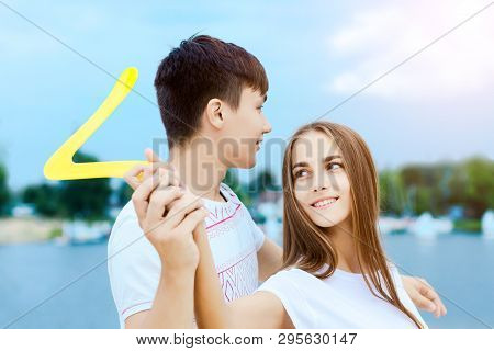 Young Smiling Woman In Light Clothes Is Holding White Racket And Ball In Her Hands. Cheerful Female 