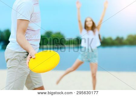 Young Smiling Woman In Light Clothes Is Holding White Racket And Ball In Her Hands. Cheerful Female 