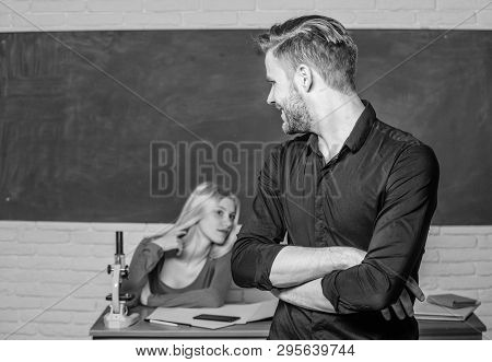 Confident In His Knowledge. Handsome Man Standing Hands Crossed In Classroom With Teacher. Male Stud