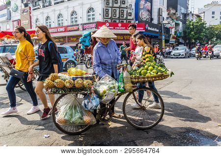 Vietnamise Saleswoman With Bike And Fruits