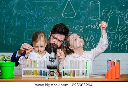 Prove It. Little Girls Performing Experiment Under Teacher Supervision. Small School Children Holdin