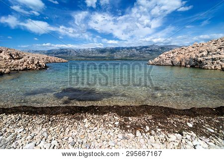 Quiet Bay With Paklenica National Park Mountains In Background. Beautiful Ocean And Dramatic Blue Sk