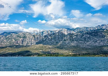 Paklenica National Park Mountains With Beautiful Ocean And Dramatic Blue Sky With Clouds On Hot Summ