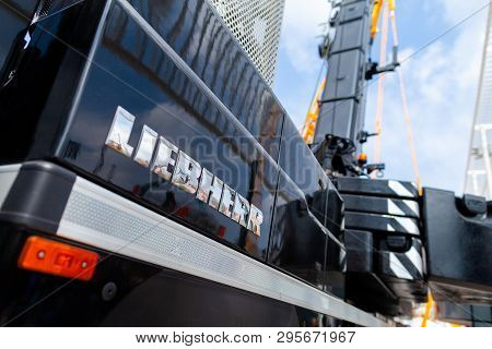 Munich / Germany - April 14, 2019: Liebherr Logo On A Black Crane At A Liebherr Machine Dealer.