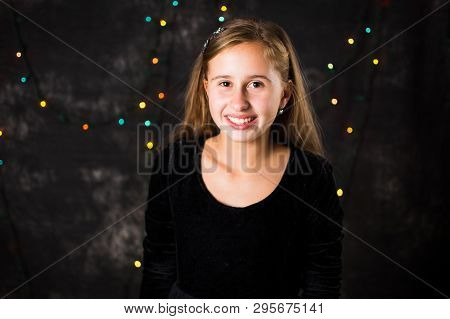 Portrait Of Cheerful Teenage Girl Against Festive Background