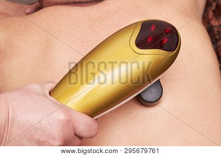 Senior Male Patient Receive Electrostatic Therapy Procedure On His Back. Electrostimulation Massage 
