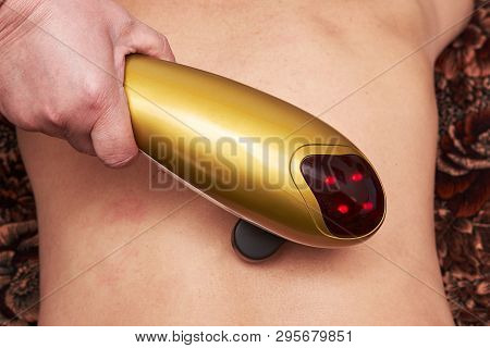Senior Male Patient Receive Electrostatic Therapy Procedure On His Back. Electrostimulation Massage 