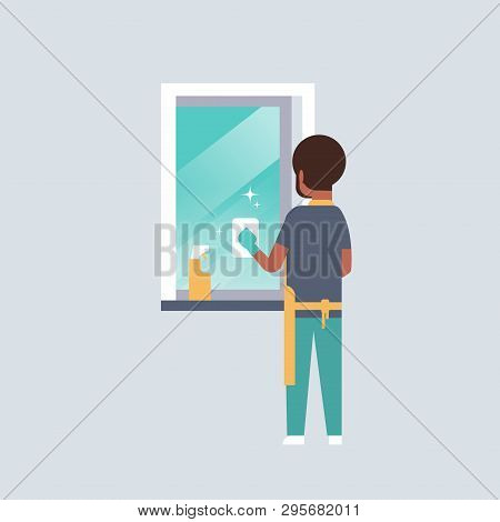 Man In Gloves And Apron Cleaning Window With Rag Cleaner Spray Rear View African American Guy Doing 
