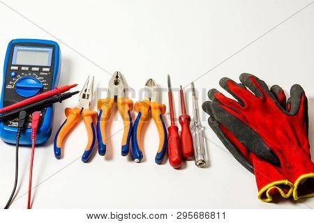 Lectronic Tester, Gloves And Screwdrivers Isolated Against White Background