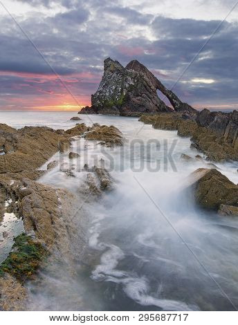 Bow-fidle Rock Sunrise Landscape On The Coast Of Scotland On A Cloudy Morning