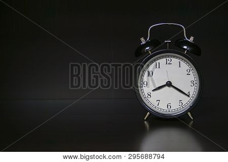 Classic Mechanical Alarm Clock On Dark Background