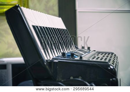 Keyboard Accordion Standing On The Table. Selective Focus