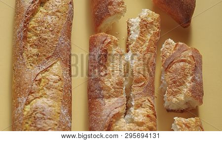 Fresh French Baguette Bread On Yellow Background.