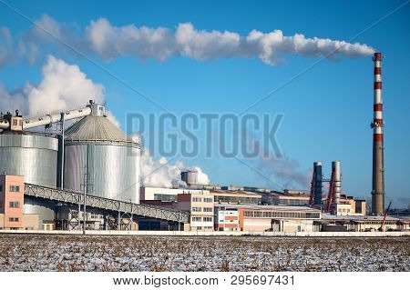 Factory Pipes With White Smoke In Winter