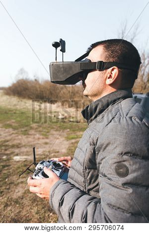 Fpv Drone Pilot In A Virtual Reality Helmet With A Remote Control From A Copter Flies In Aircraft Ou