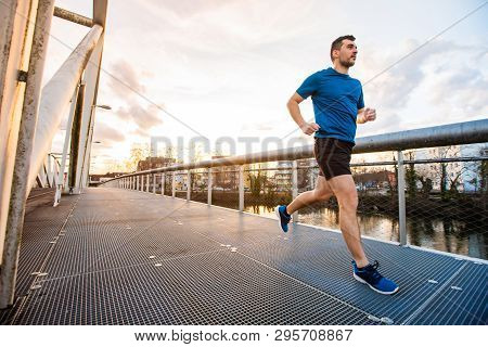 Running Man Runner Training Doing Outdoor City Run Sprinting Over A Bridge. Urban Healthy Active Lif