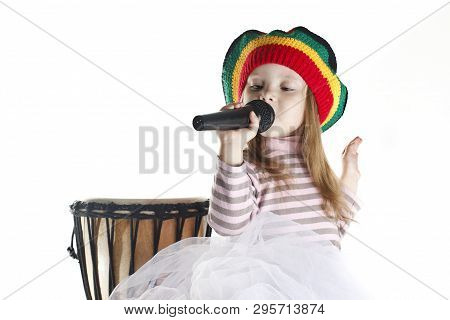 Joyful Rastafarian Toddler Girl Sinnging In A Microphone And A Drum