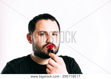 A Man Paints His Lips With Lipstick