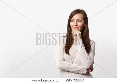 Pretty Smiling Young Woman In Light Clothes Looking Aside, Put Hand Prop Up On Chin Isolated On Whit
